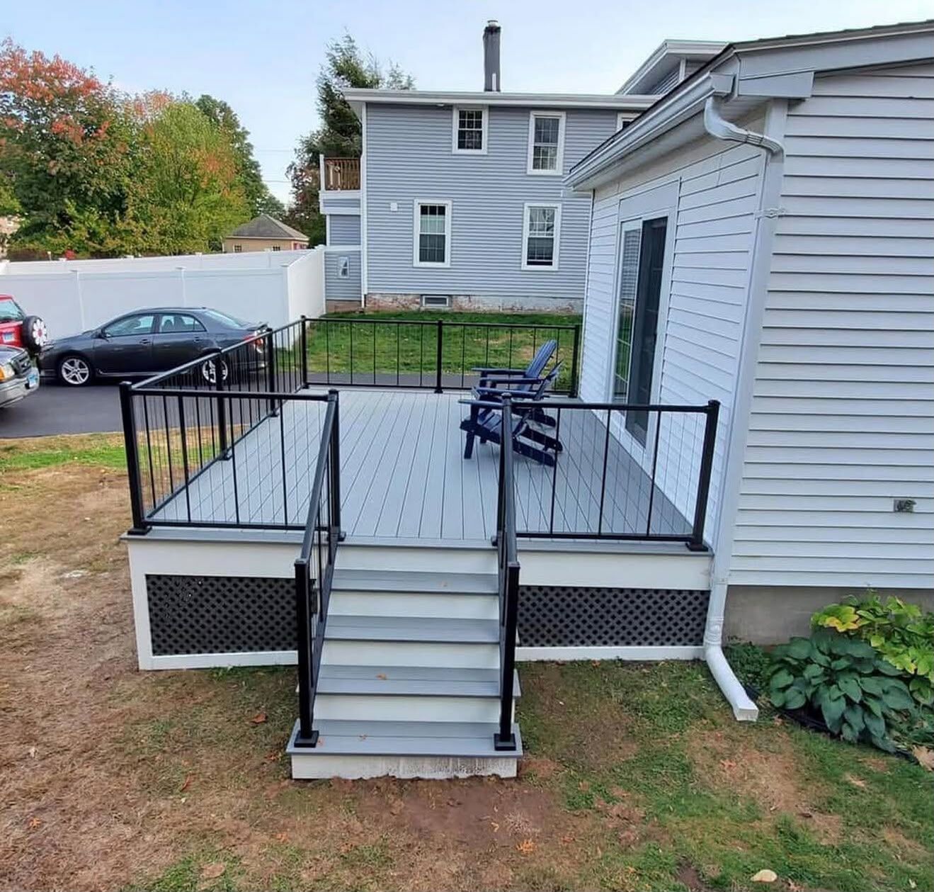 Composite backyard deck with black aluminum railing and stairs